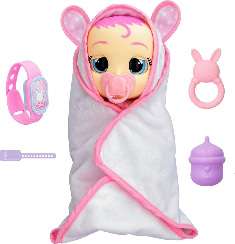A baby doll wrapped in a white blanket with pink trim, surrounded by accessories.