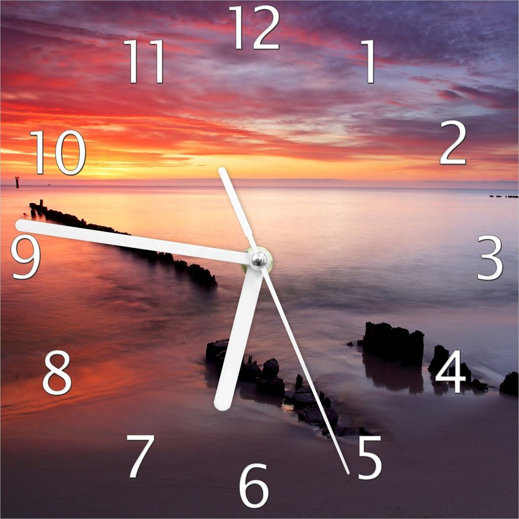 Wallario Design Wanduhr Sandstrand im Sonnenuntergang - Roter Himmel aus Echtglas, Größe 20 x 20 cm