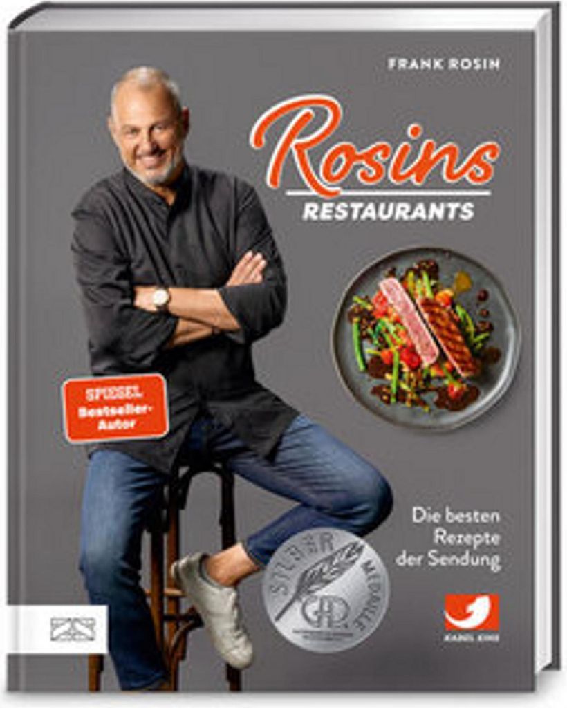 A man sitting on a stool in front of a book cover.