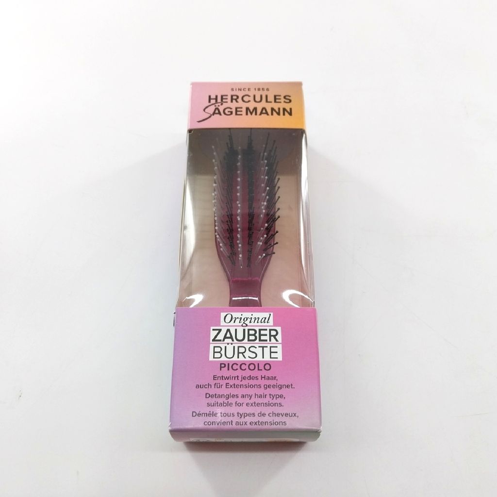A packaged hair brush is shown against a white background.