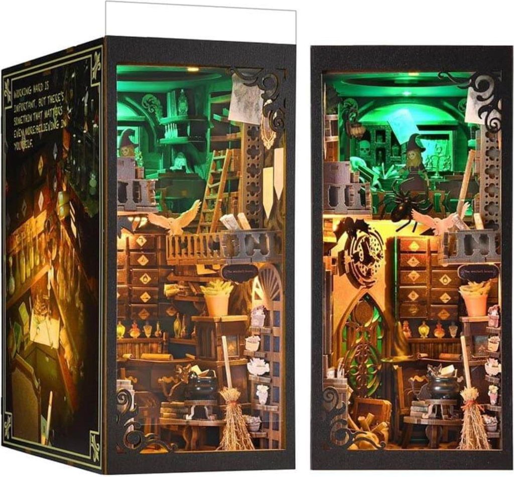 A diorama of a magical workshop or library, with shelves filled with potions, books, and other mystical items, illuminated by green lights.