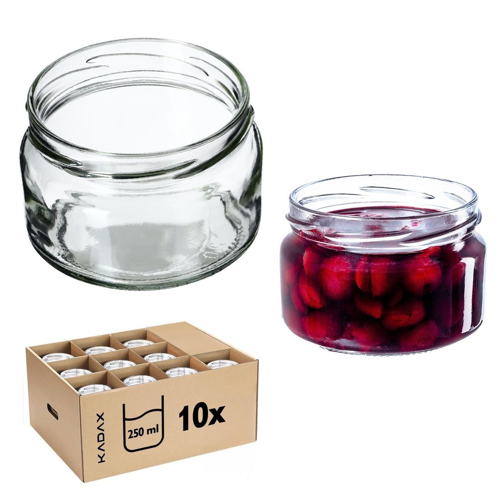 A collection of glass jars, some empty and one filled with red fruit, along with a cardboard box containing multiple jars.