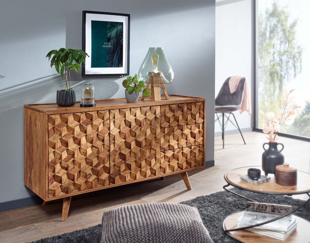 A living room scene featuring a wooden sideboard, coffee table, and chair.