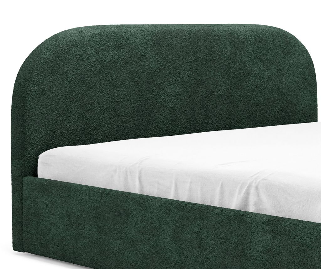 A close-up view of a dark green upholstered bed frame and headboard with a white sheet on the mattress.
