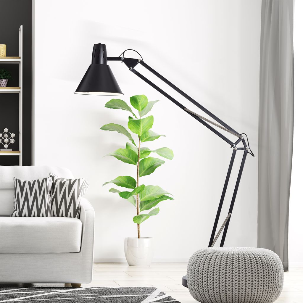 A modern living room scene with a floor lamp, sofa, and pouf.
