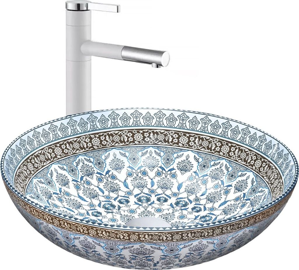 A white faucet is positioned behind a decorative basin.