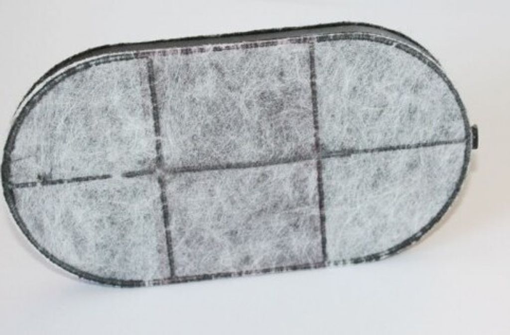 An oval-shaped charcoal filter for a deep fryer, seen from above.