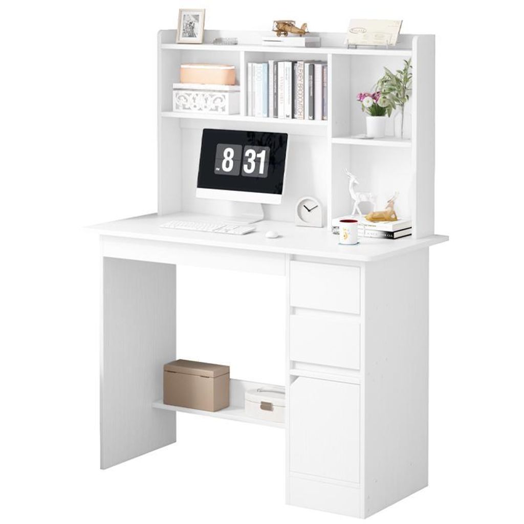 A white computer desk with shelves and drawers, featuring a monitor, keyboard, mouse, clock, and decorative items.