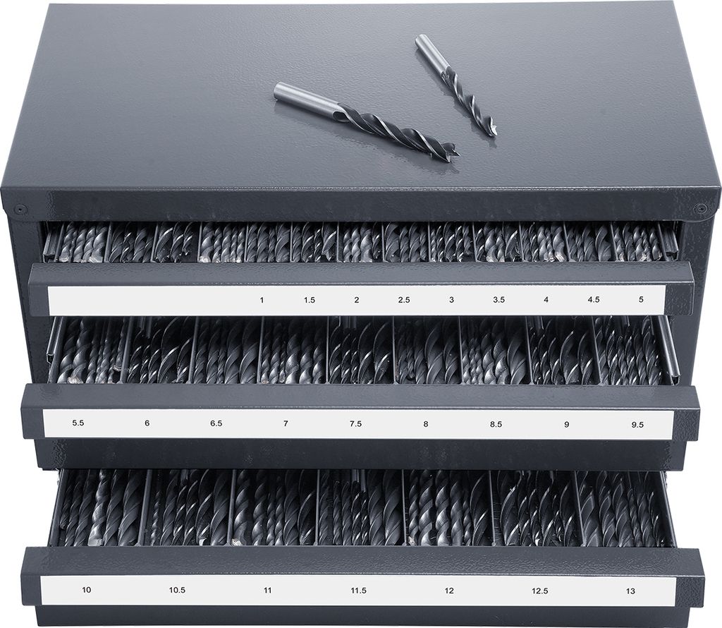 A gray metal cabinet with three drawers filled with drill bits. Two drill bits are placed on top of the cabinet.