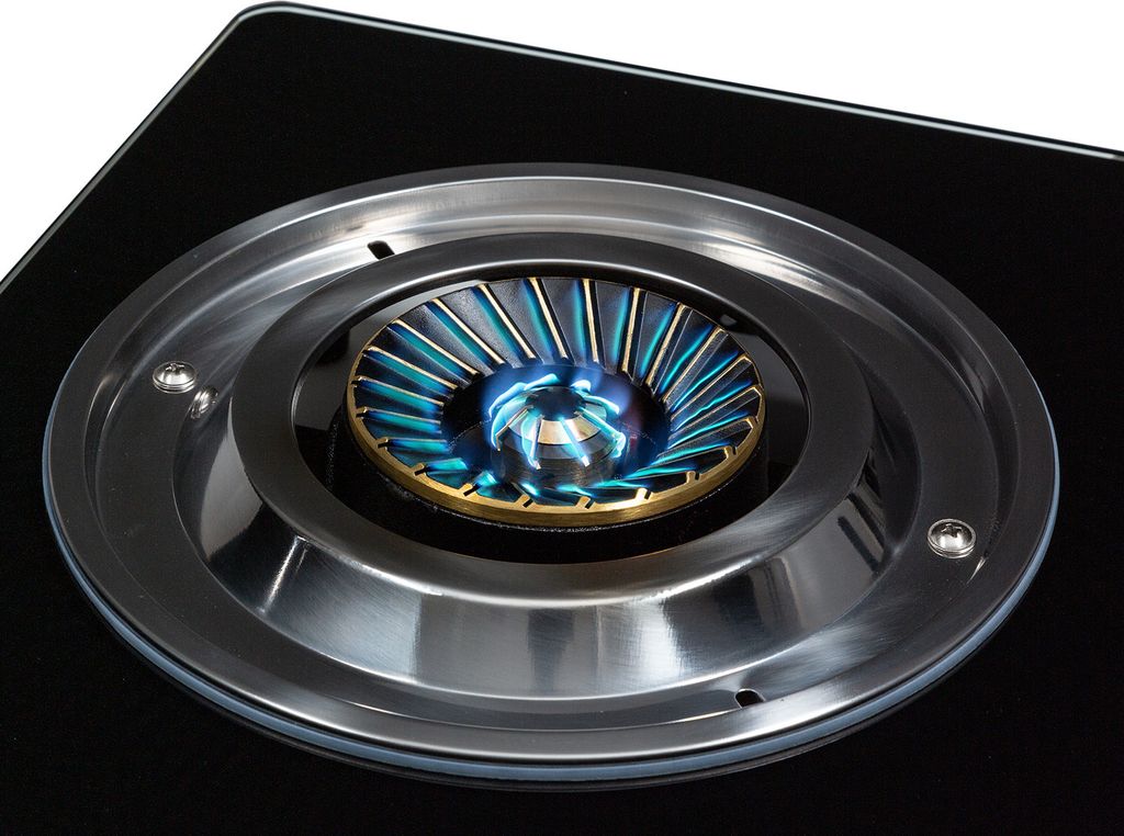 A close-up view of a gas burner on a black stovetop.