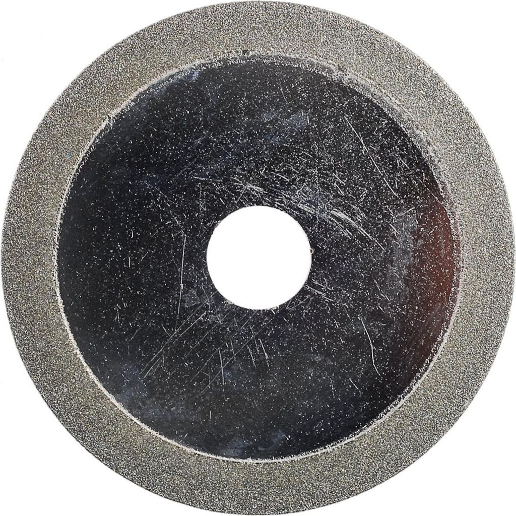 A close-up, top-down view of a diamond-coated saw blade with a central hole.