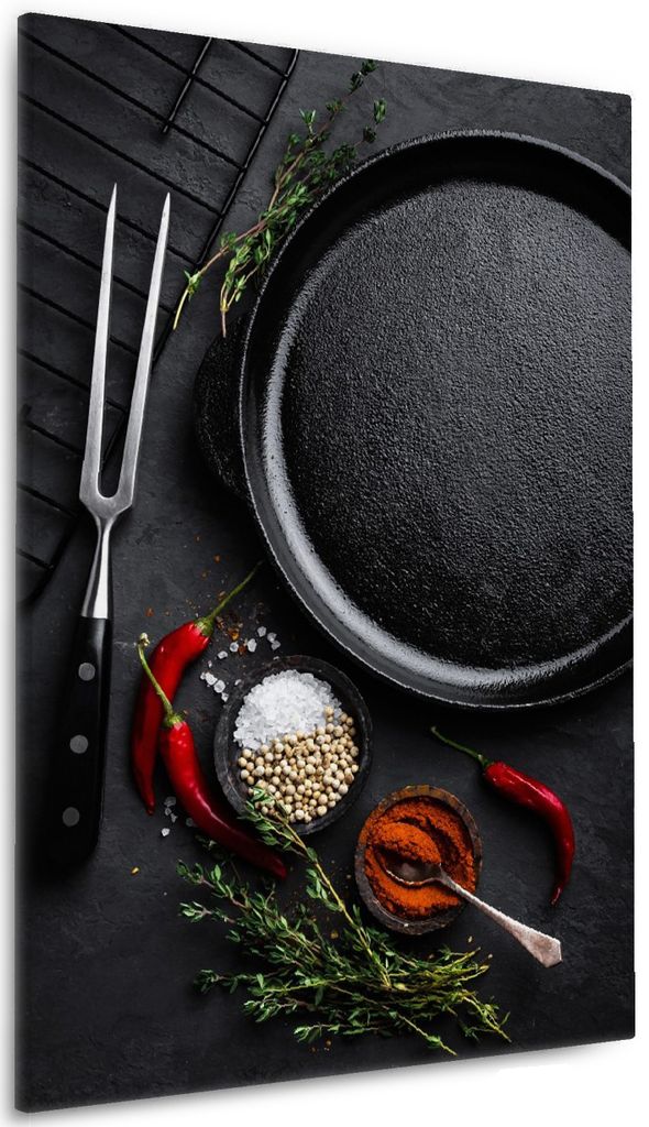 Wallario Premium Leinwandbild Chili und Pfeffer - Gewürze neben einer Eisenpfanne in Größe 60 x 90 cm