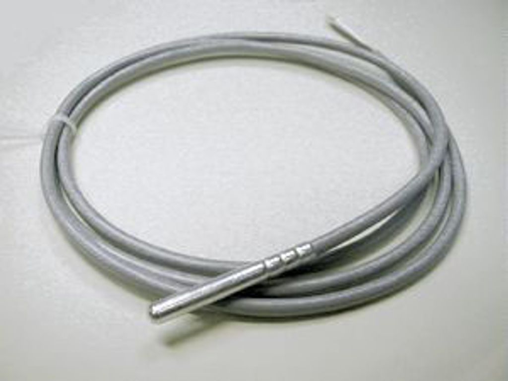 A coiled gray cable with a silver metal end lies on a white surface.