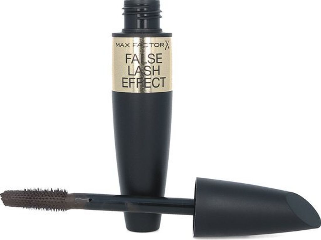 A black mascara tube with a gold label and its applicator brush are shown against a white background.