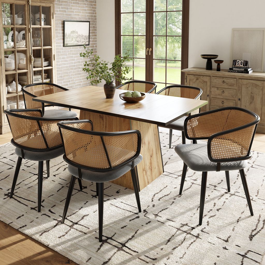 A dining room set with a wooden table and six chairs with rattan backs and gray upholstered seats.