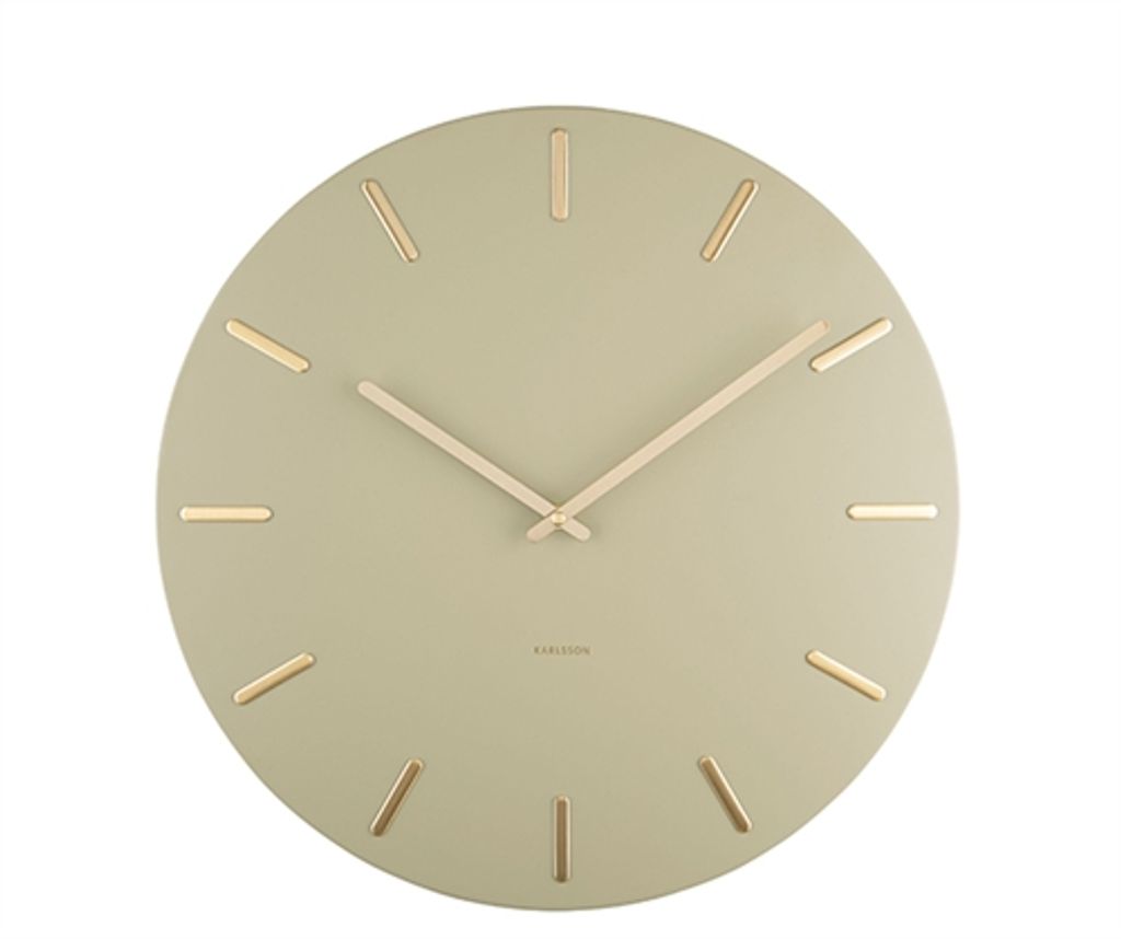 A round wall clock with gold hour markers and hands on a light green face.