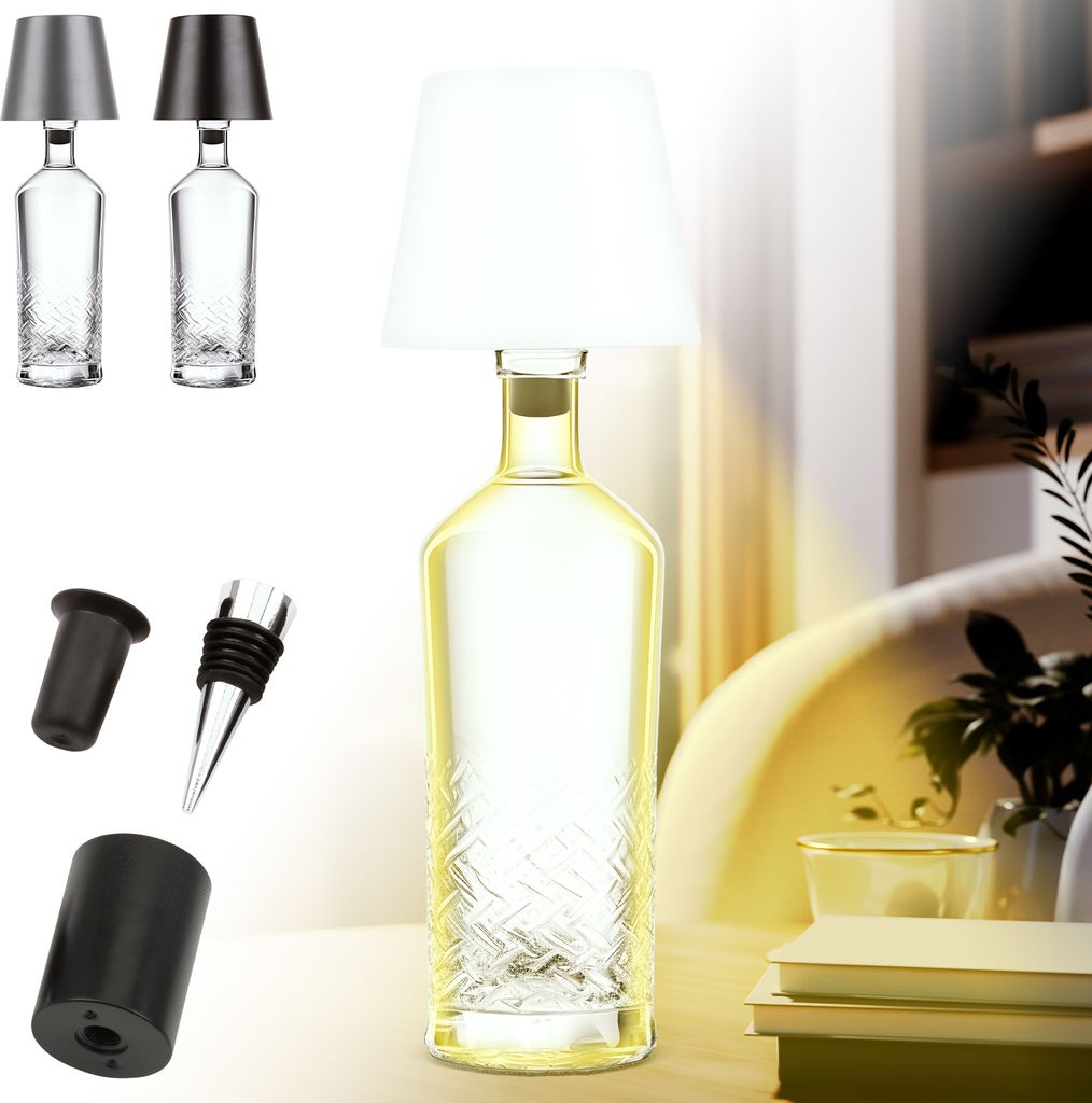 A lamp made from a clear glass bottle with a white lampshade, displayed on a desk with books and plants in the background.
