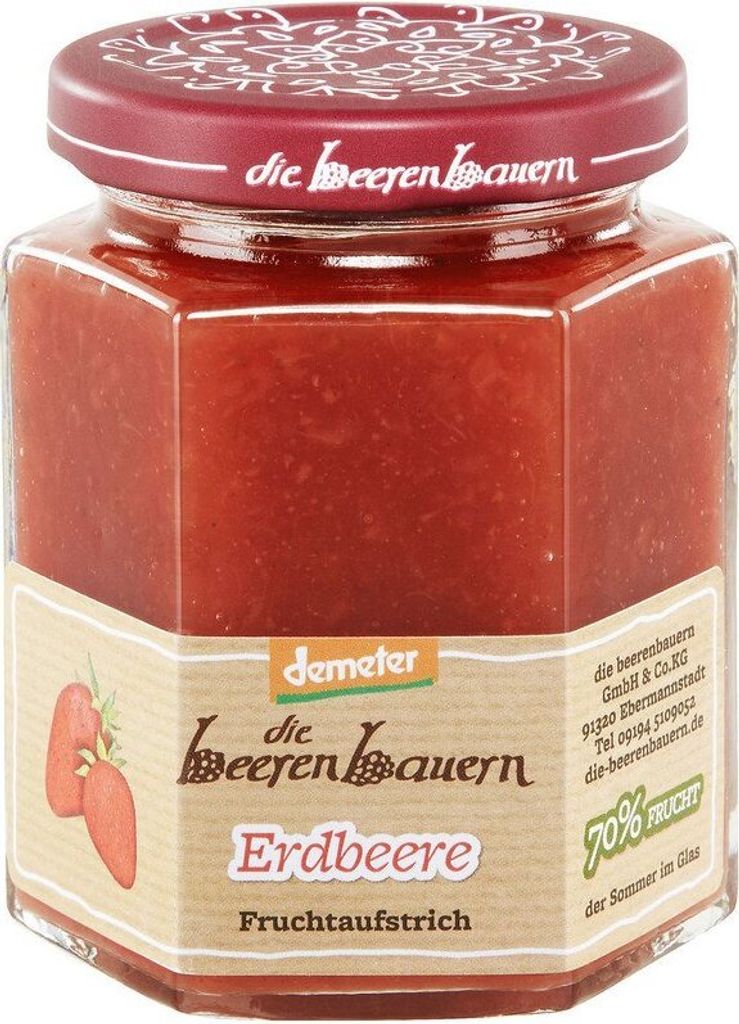 A jar of strawberry jam on a white background.