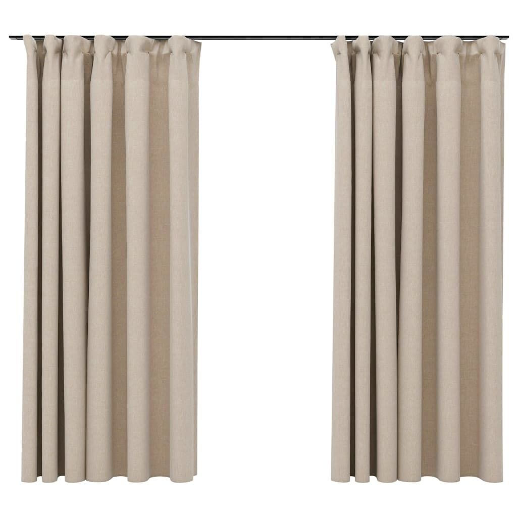 Two beige curtains hanging from a curtain rod against a white background.