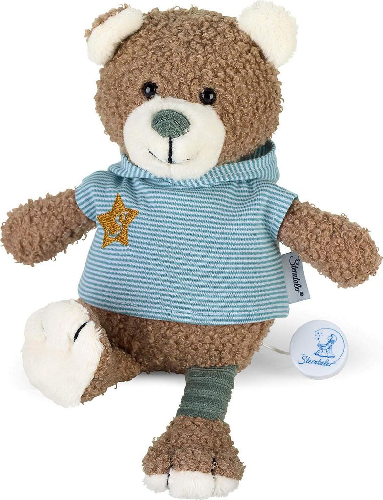 A brown teddy bear wearing a blue and white striped hoodie with a yellow star on it, sitting with one leg extended.