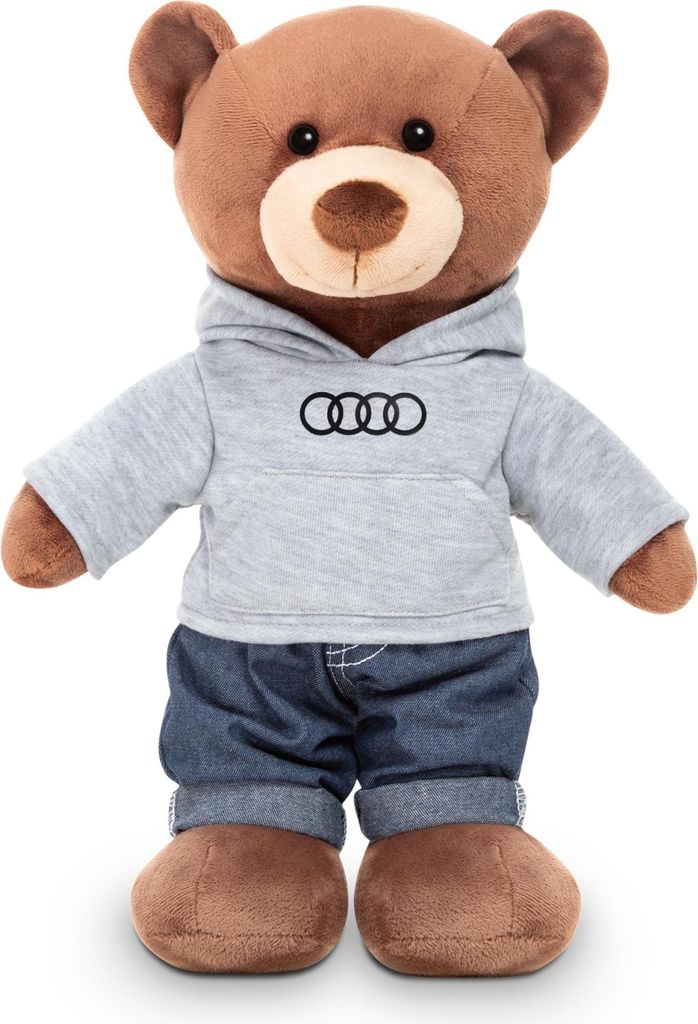A teddy bear wearing a hoodie and jeans, standing against a white background.