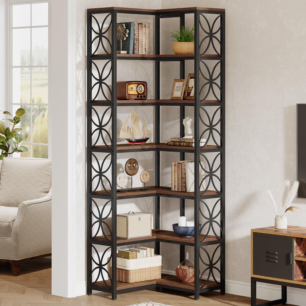 A corner bookshelf filled with decorative items and books, set in a living room with a couch visible in the background.