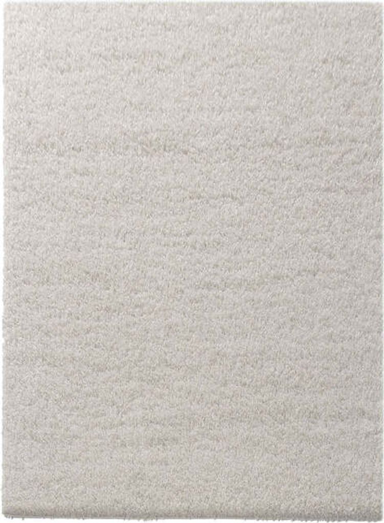A close-up view of a cream-colored shaggy rug.