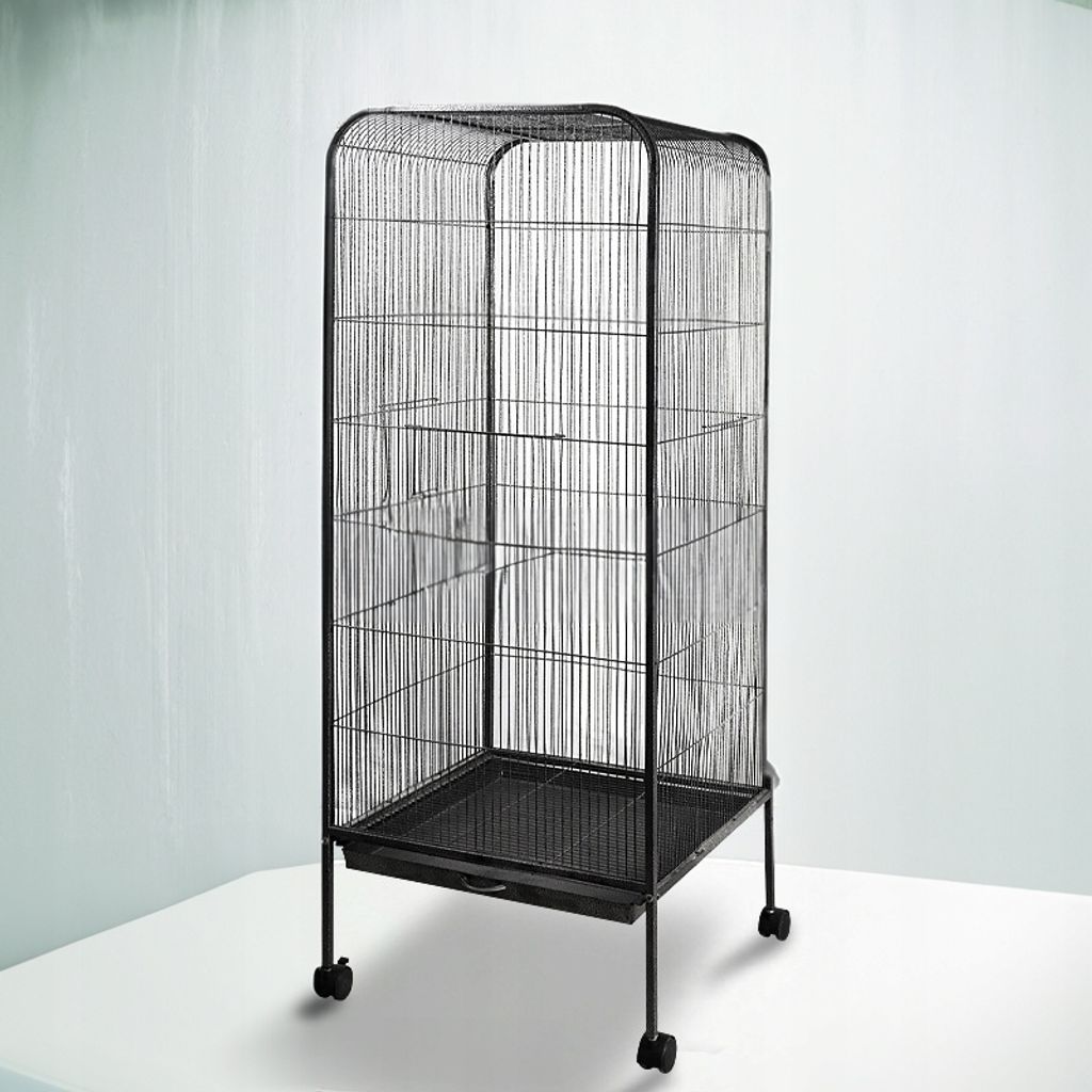 A tall, black bird cage with a tray at the bottom and wheels, set against a light gray and white background.