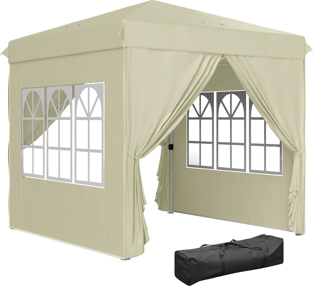 A beige pop-up gazebo with windows and curtains, shown outdoors with a black carrying bag in the foreground.
