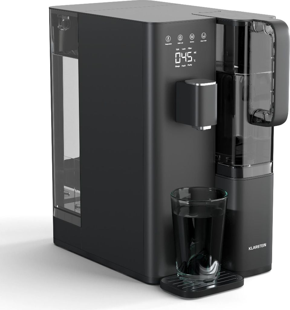 A black water purifier with a glass of water in front of it, set against a white background.