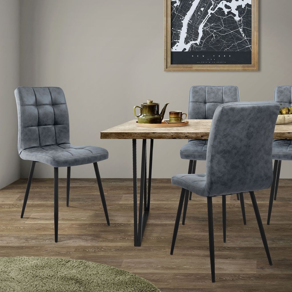 A dining room setting with chairs around a table.