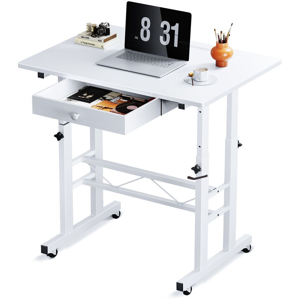 A white adjustable height desk with a laptop, books, and art supplies on it.