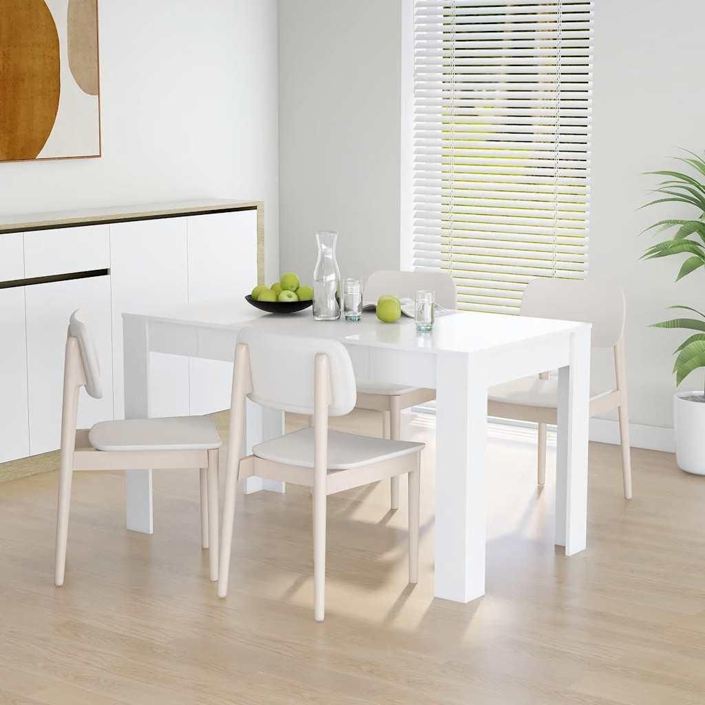 A dining table with chairs in a bright, modern room.