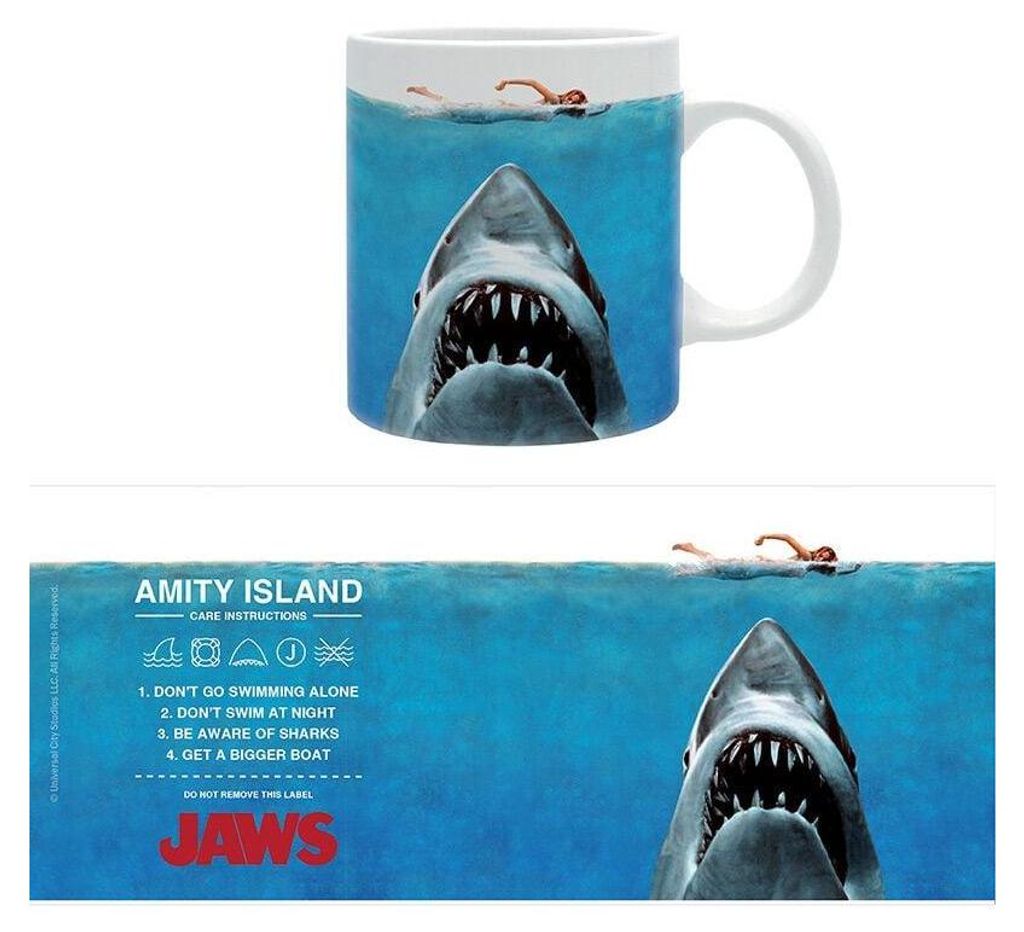 A mug with a Jaws movie theme, showing a shark and a swimmer, with care instructions and movie title on a separate strip below.