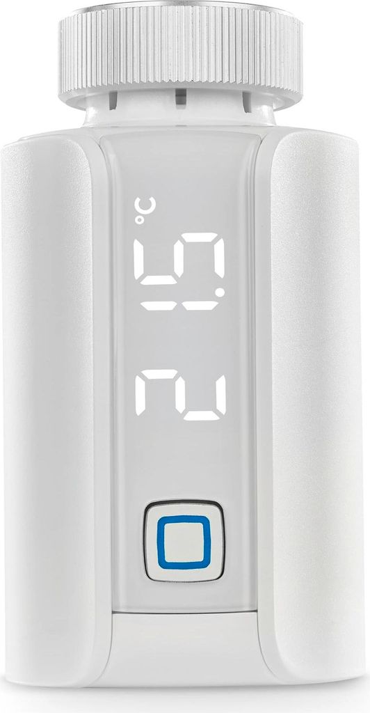 A white smart thermostat with a digital display showing temperature.
