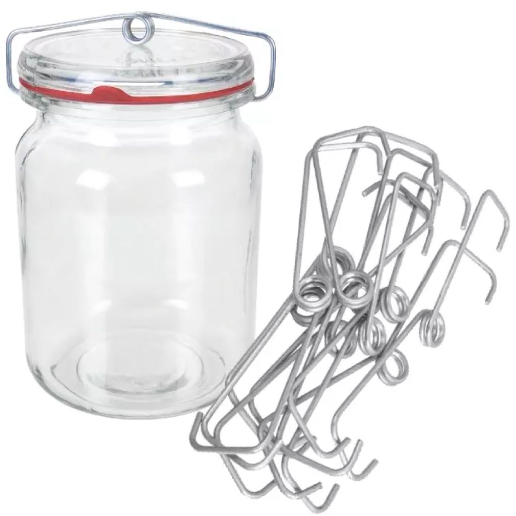 A glass jar with a wire bail lid and a red rubber seal, next to a pile of metal spring clips.