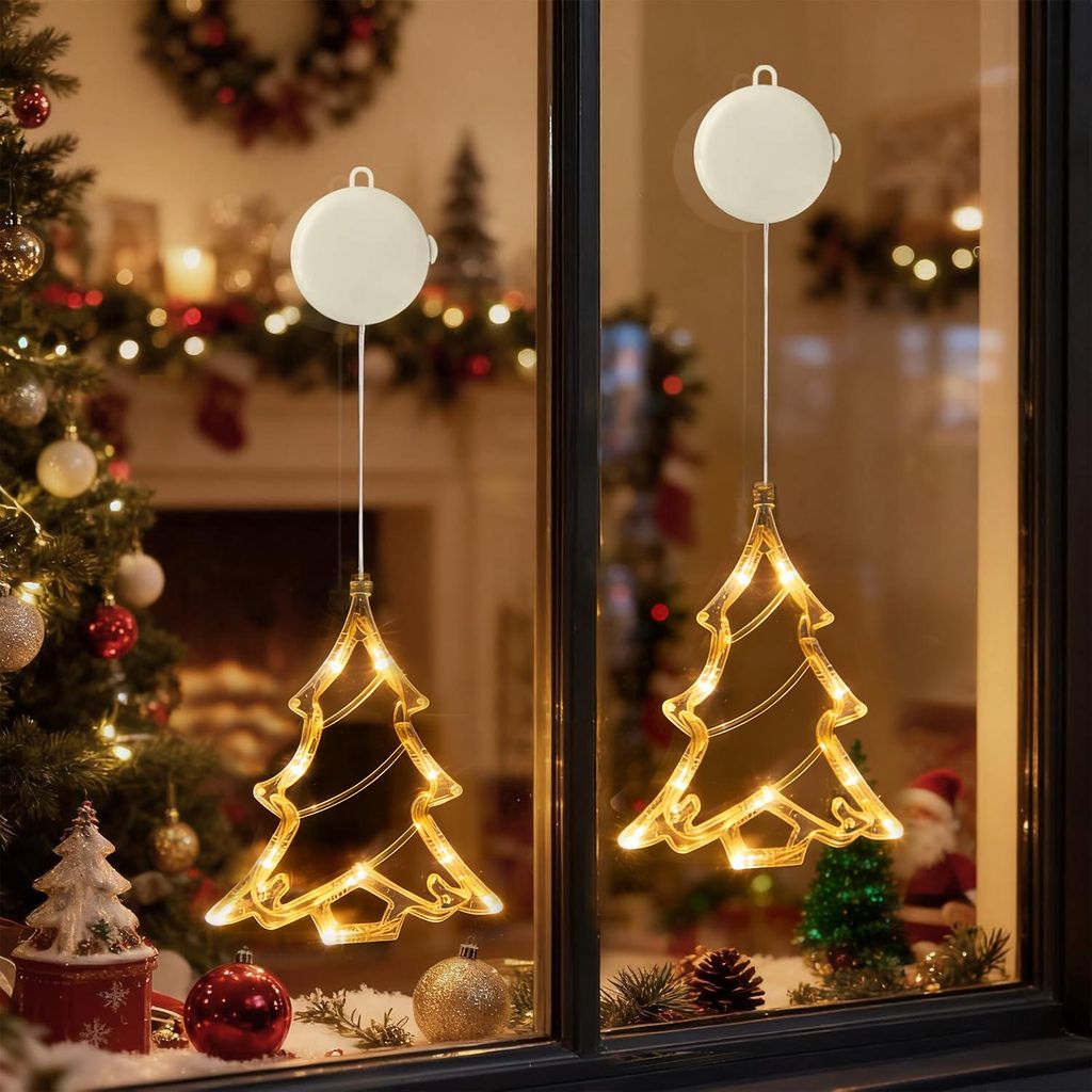 Christmas decorations on a window, including two illuminated Christmas tree lights.