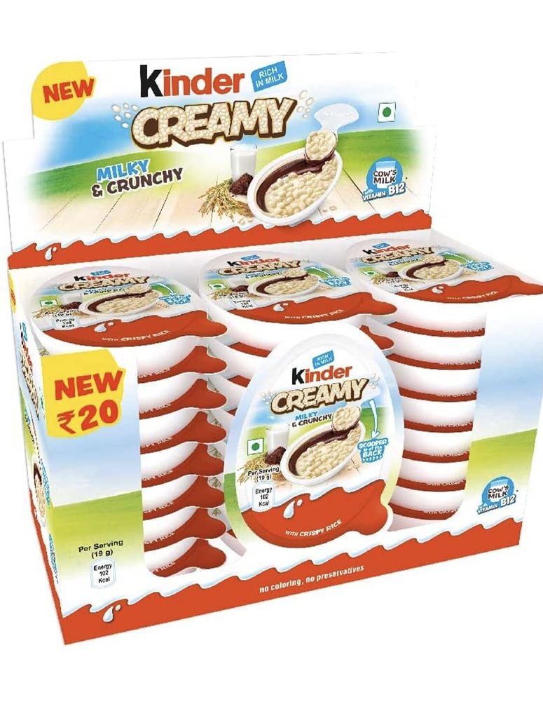 A display box of Kinder Creamy Milky & Crunchy snacks.