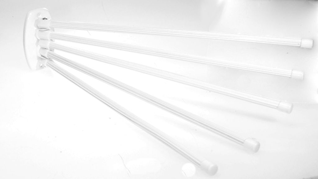 A white towel rack with five arms is shown against a white background.