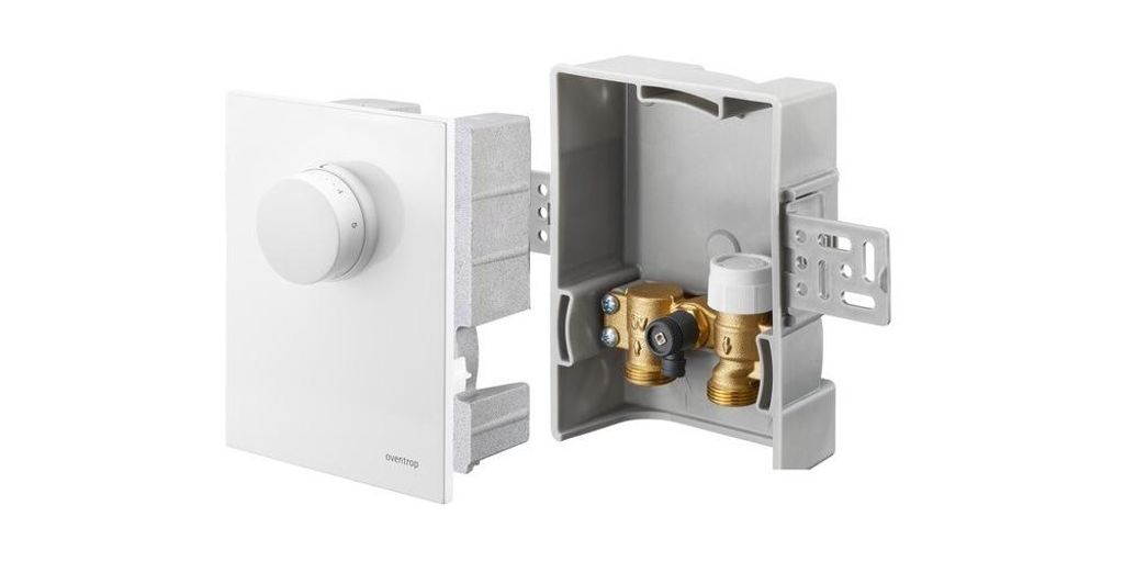 A white thermostat control unit and its grey housing with brass fittings are shown against a white background.