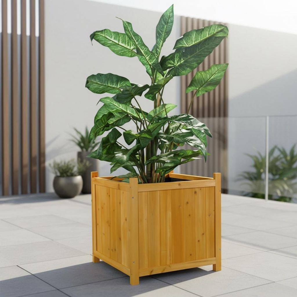 A large plant in a wooden planter sits on a tiled patio.