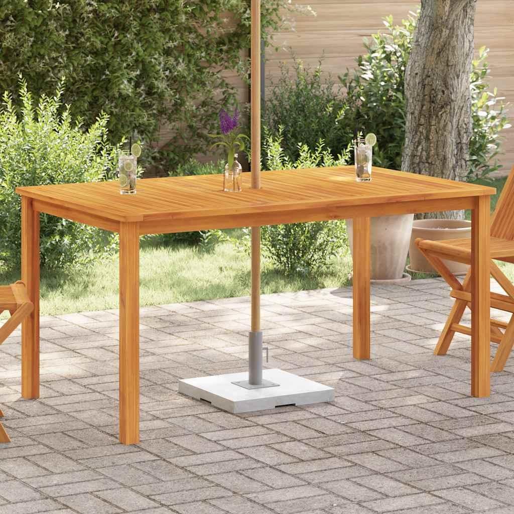 An outdoor patio setting with a wooden table and chairs, featuring drinks on the table.