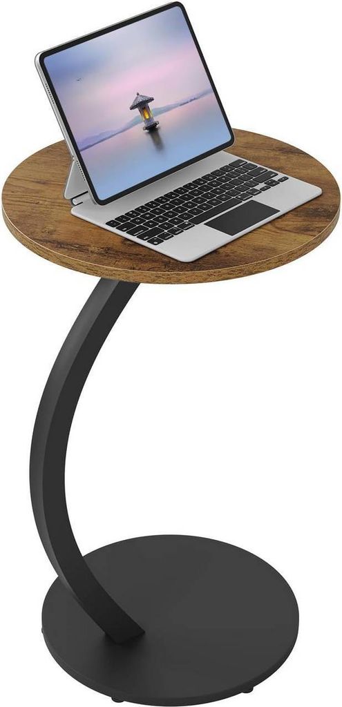 A round side table with a wooden top and a black metal base, holding a laptop with a keyboard and a tablet.