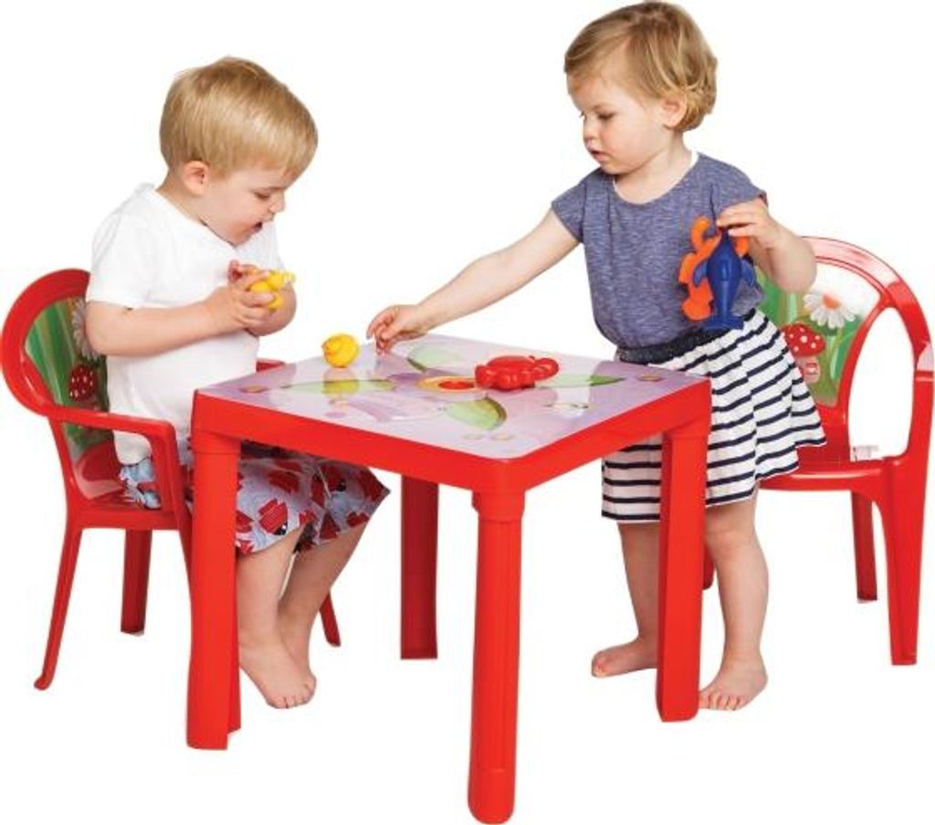 Two young children are playing at a red table with toys.