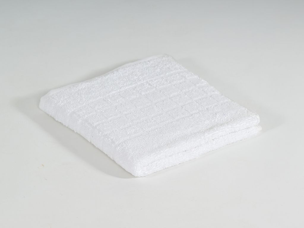 A white towel folded and placed on a white surface.