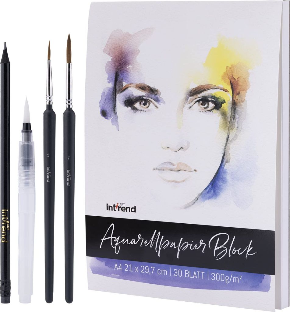 A watercolor paper block and art supplies are laid out on a white background.