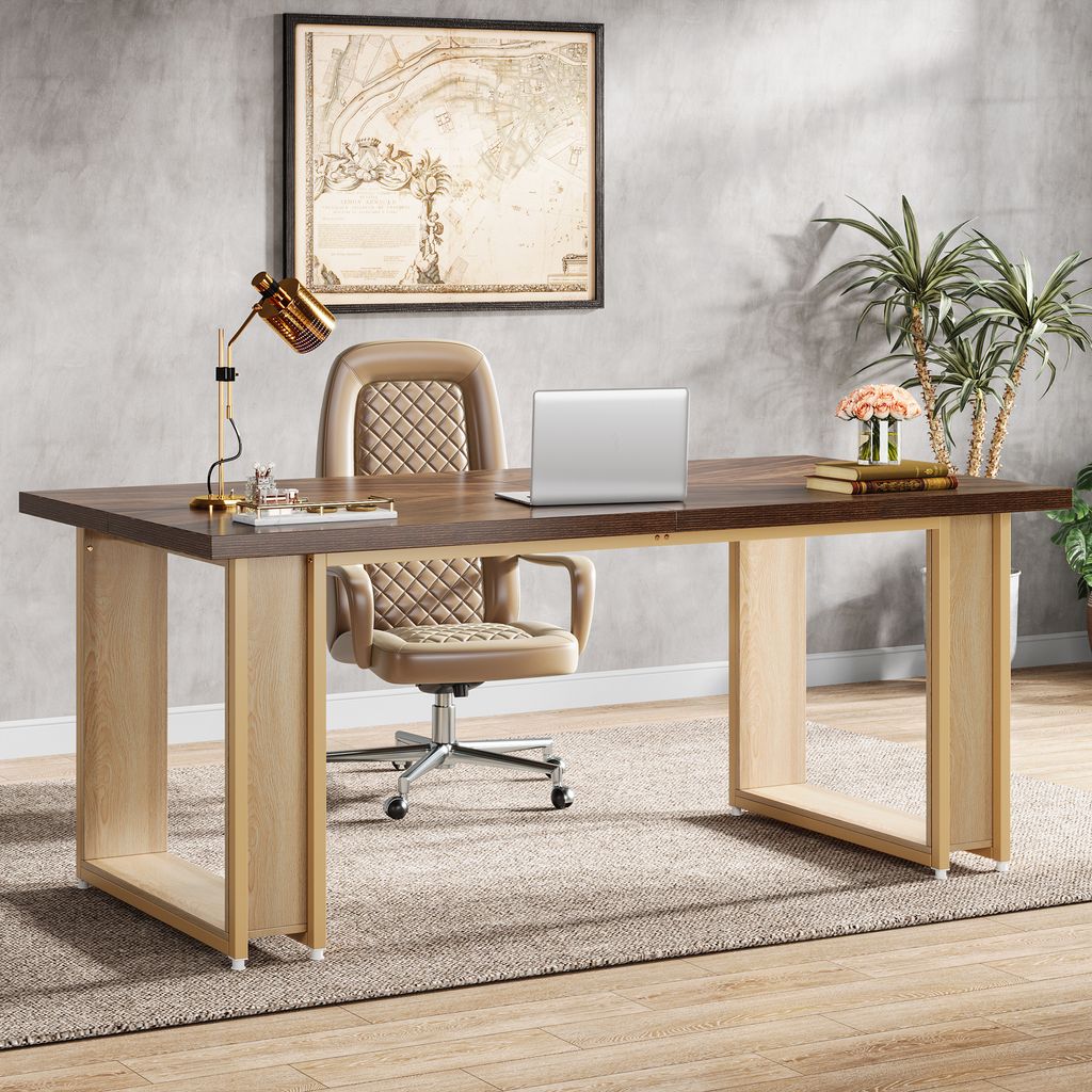 A modern office setup with a large desk, chair, laptop, and decorative items.