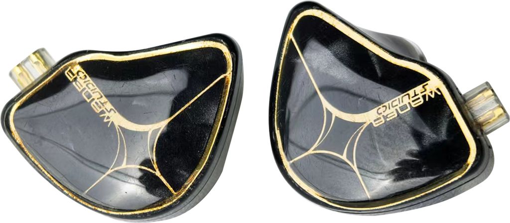 A pair of black and gold in-ear monitor headphones are shown against a white background.
