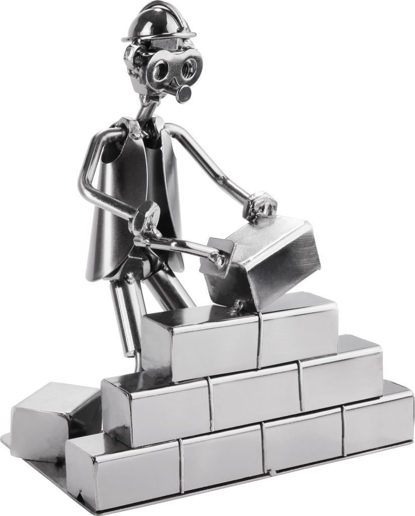 A metal figurine of a construction worker laying bricks.