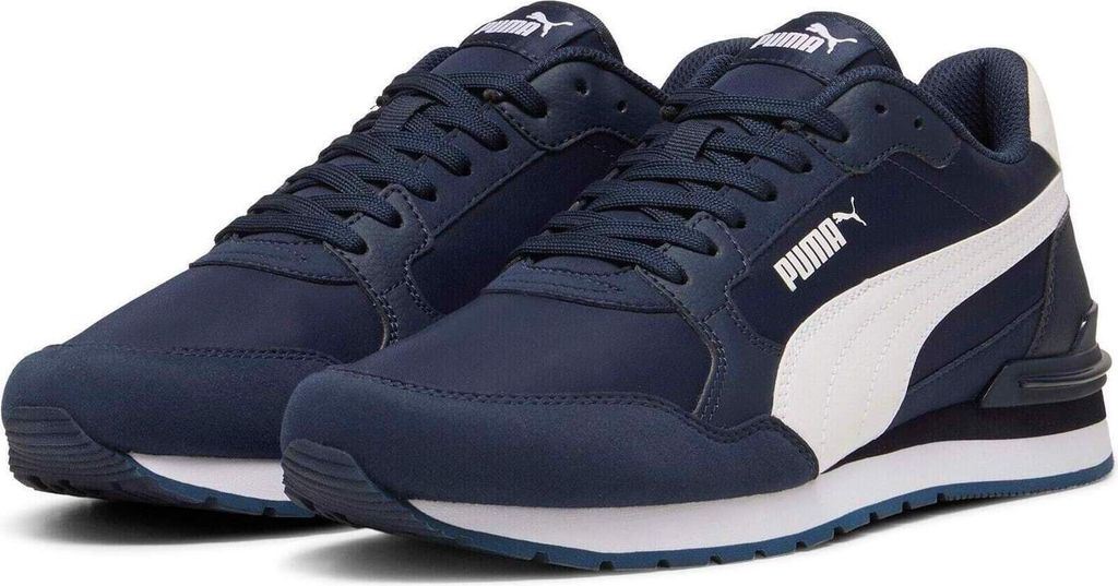 A pair of navy blue Puma sneakers with a white stripe on the side, shown from a slightly elevated front-left angle against a white background.